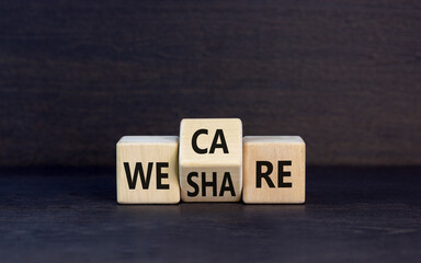 We share and care symbol. Concept word we share we care on wooden block. Beautiful grey table grey background. Business we share and care sharing is caring concept. Copy space.