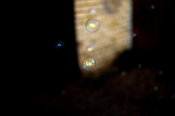 Some blurred and sharp soap bubbles on a light and dark background
