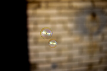 Blurred and sharp soap bubbles on a light background