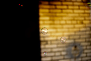 Blurred and sharp soap bubbles on a light and dark background