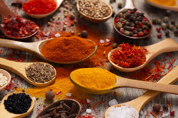 Variety of spices in spoon at table background. Cooking concept and ingredients on kitchen
