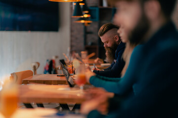 Man writing on notebook at the cafe