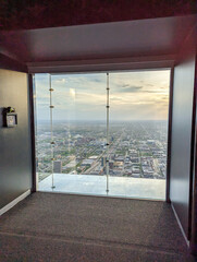 looking out window at skydeck of willis tower in chicago