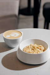 Oatmeal porridge with coffee. Concept healthy breakfast food, modern mood