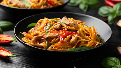 Stir fry chow mein noodles with pork and vegetable in black bowl. asian style food