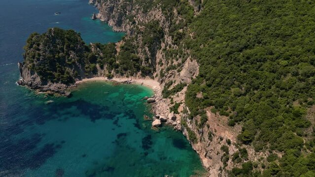 Drone footage of boats gently swaying in the sunny sea, moored not far from the Paralia Ermones Beach, on a hot day
