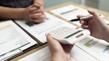 Female calculating personal financial for future plan at her home, taxes payment.