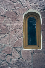 Ancient arched church windows on a stone wall. Selective focus, street view. High quality photo