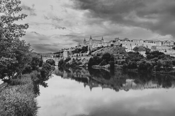 Black and white view of the Spanish city of Toledo, a UNESCO World Heritage Site, with the Tagus...