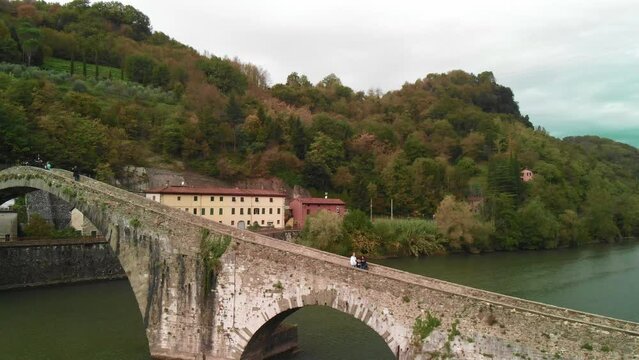 Aerial overhead view of Devils Bridge-Ponte della Maddalena is a bridge crossing the Serchio river near the town of Lucca