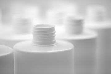 Close up of a white plastic bottle, plastic packaging industry concept background