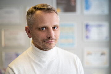 Fototapeta premium portrait of handsome adult man in a white sweater