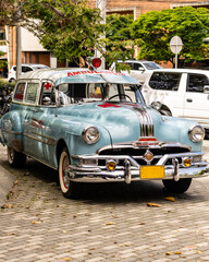 cars of the parade of vintage cars at the flower fair in medellin colombia