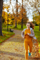 woman in fitness clothes in park running