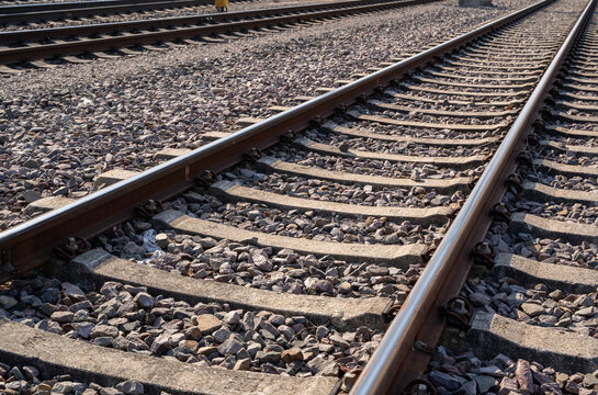 Close up of rusty railroad tracks with gravel stones