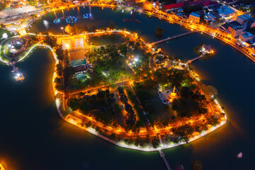 Aerial view of residential neighborhood roofs. Urban housing development from above. Top view. Real estate in Roi et province city, Thailand. Property real estate at night.