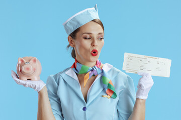 surprised elegant female flight attendant on blue