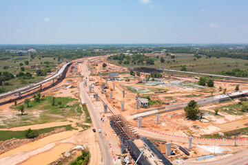 Aerial view of construction tractor car, bulldozer, or backhoe digging road or street in traffic transportation and agriculture concept. Engine working in urban city town.