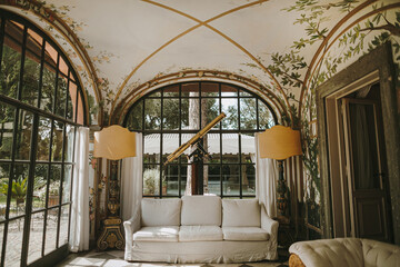 Classic Renaissance styled home interior design with sofa, wide windows, telescope. Elegant veranda...