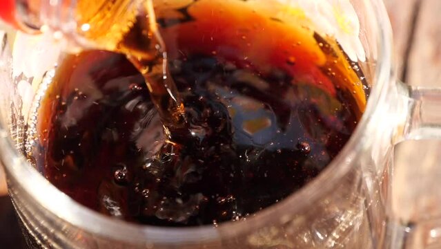 Coca-Cola is poured into a glass
