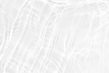 White water with ripples on the surface. Defocus blurred transparent white colored clear calm water surface texture with splashes and bubbles. Water waves with shining pattern texture background.