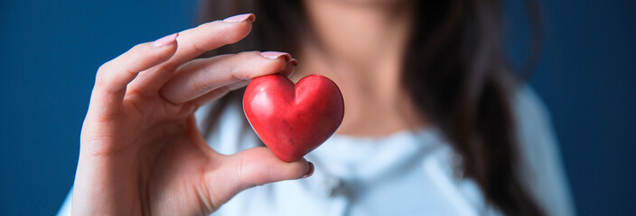 woman hand holding red heart