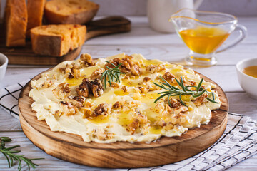 Butter board with honey and nuts sweet dessert on the table