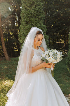 Happy stylish bride with wedding bouquet enjoying the best day of her life
