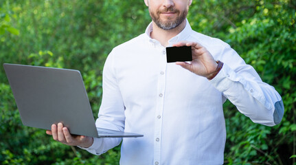 cropped view of businessman offer online banking with card outdoor