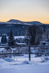 View on the Roklany mountains, fence, trees and Filipova Hut under the snow