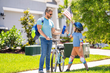 father and son promenade. father and son in fatherhood. fatherhood of father and son cycling at sunlit park. father and son navigate the winding paths together. Fatherhood in motion