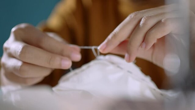Code-up, seamstress sewing with electric sewing machine.