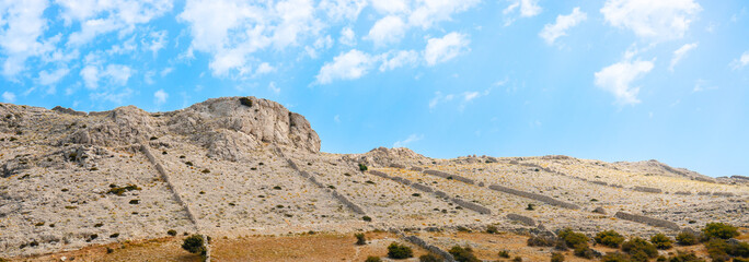 Beautiful sandy beach and mountains on the island of Pag, beautiful rocky mountains in the blue sea, landscape seaside photography on a warm summer day