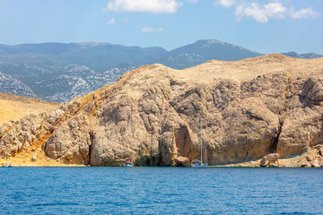 Beautiful sandy beach and mountains on the island of Pag, beautiful rocky mountains in the blue sea, landscape seaside photography on a warm summer day