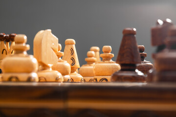 Handmade wooden chess, close-up of a piece on a chessboard