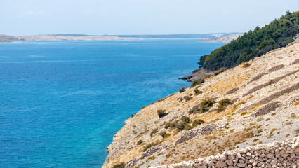 View of a beautiful beach, hills, sea bays, mountains on a sunny summer day. Top view of the blue sea with clear water