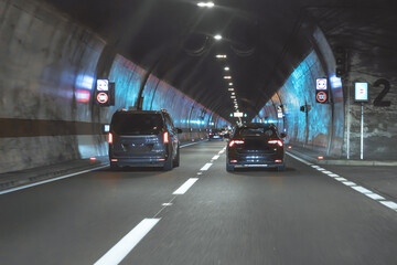 Illuminated road tunnel located in the mountains