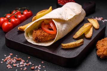 Delicious roll with chicken nuggets, tomatoes, lettuce and sauces with salt and spices