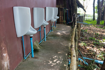 Outdoor men's toilets - urinals in the forest restaurant, Thailand