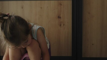 One small caucasian baby girl sitting on the children's potty at home on the floor. Baby learning to go to the toilet on lifestyle potty