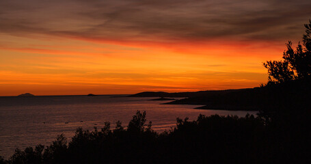 Colors of evening sky above beautiful and picturesque coastline of Adriatic Sea