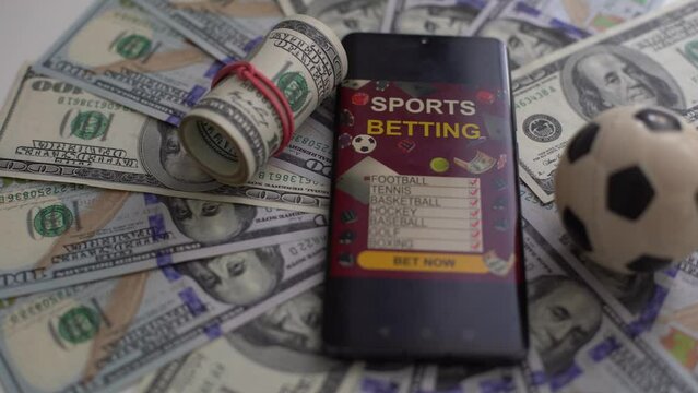 Monitor with champion cups, sport balls and gold coins in dark scene with neon rhombus frames and hologram of digital rings