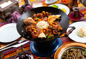 Traditional Turkish Choban Kavurma, hot stewed lamb meat with vegetables served with rice and bread