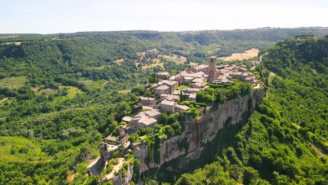 Panoramic aerial view of Civita di Bagnoregio from a flying drone around the medieval city, Italy