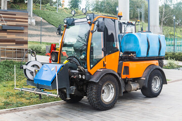 small tank truck for cleaning paths and watering plants in the city park