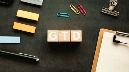 There is wood cube with the word GTD. It is an abbreviation for Getting Things Done as eye-catching image.