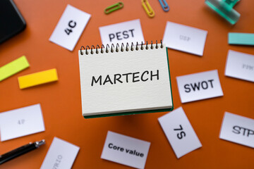There is notebook with the word MARTECH. It is as an eye-catching image.