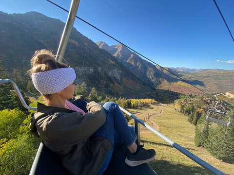 Woman sitting on a ski lift in mountains, Sundance, Utah, USA