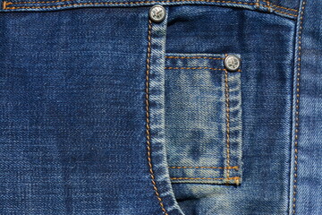 Double pocket with studs in blue jeans. View from above