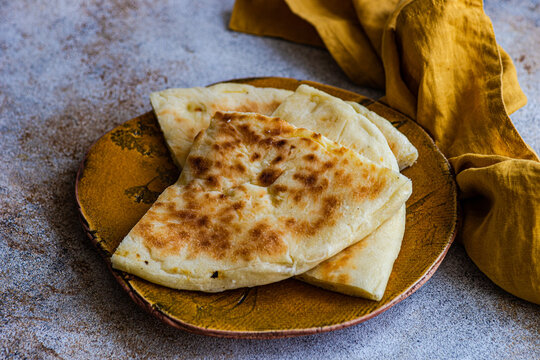 Close-up of Georgian cheese bread slices (Imeruli khachapuri) on a plate